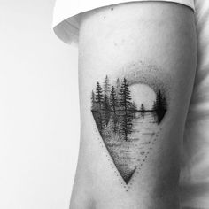 a black and white photo of trees in the shape of a heart on a woman's thigh