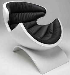 a black and white chair sitting on top of a white base with an oval shaped seat