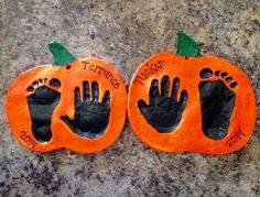 two pumpkins with hand and foot prints on them