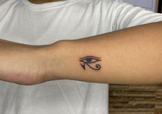 a man's arm with an eye tattoo on the left side of his arm