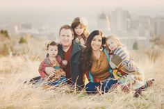 a family poses for a photo in the tall grass