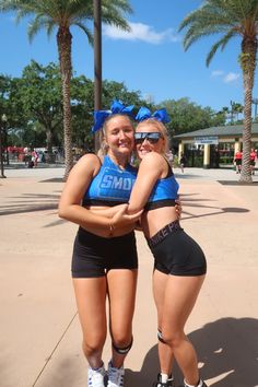 two young women in sports gear posing for the camera with their arms around each other