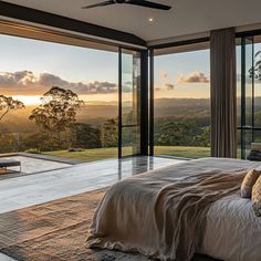 a bedroom with large windows and a view of the hills outside it is shown in this image