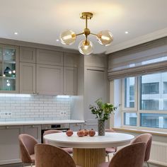 a dining room table with four chairs around it