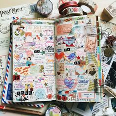 an open notebook with lots of stickers and other items on top of the pages