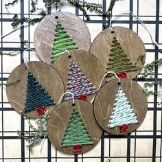 four christmas tree ornaments hanging from a wire