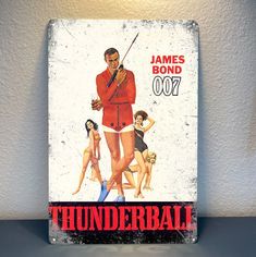 an old tin sign advertising the james bond 007 movie starring'thunderball '