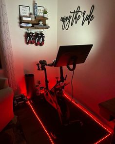 there is a bike with red lights on it in the room that says, enjoy the ride