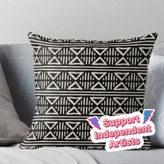 a black and white pillow with the words support independent artists on it