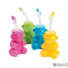 three plastic bear shaped toothbrush holders in different colors