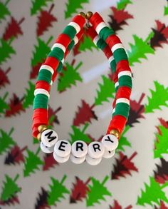 a red, white and green beaded bracelet with merry written on it