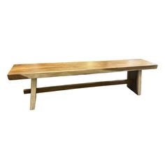 a wooden bench sitting on top of a white wall