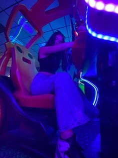 a woman is sitting on a ride at the amusement park