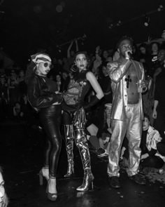 three people dressed up in costumes at a party