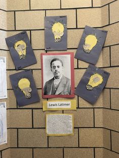 a bulletin board with some pictures on it and lightbulbs in the background