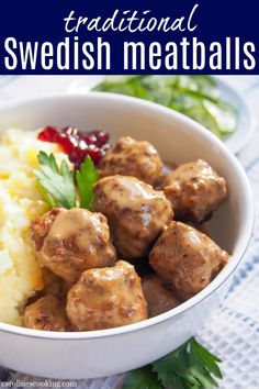 a white bowl filled with meatballs and mashed potatoes on top of a table