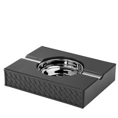 a black box with a metal lid on it's side and a silver object in the middle