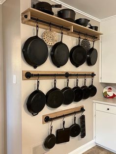 pots and pans are hanging on the wall