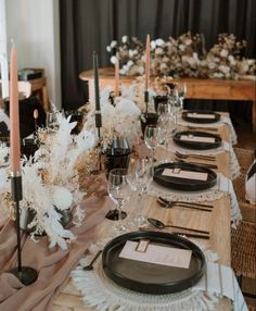 the table is set with black and white place settings