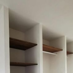 empty white shelves in a room with no furniture