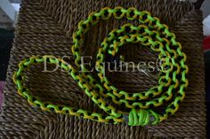 a green and yellow lanyard on top of a wicker table