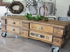 a wooden table with drawers and wheels on it