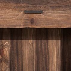 a close up of a wooden shelf with an object on it's bottom section