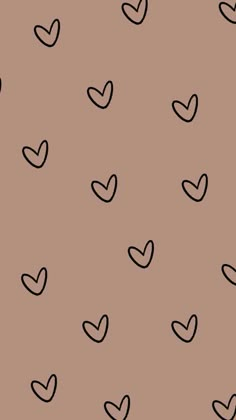 black and white hearts are drawn on a brown background, with small dots in the middle