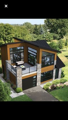 an aerial view of a modern house in the woods