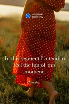 a woman in a red polka dot dress is walking through the grass with her hand on her hip