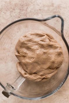 a doughnut in a glass bowl on a counter