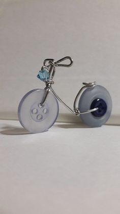 a glass bicycle with a blue wheel and handlebars is shown in front of a white background