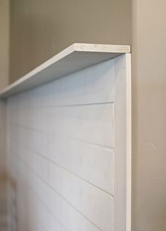 the corner of a wall with a shelf on it