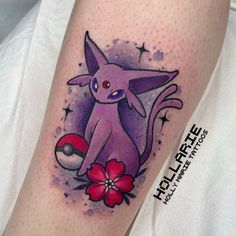 a pokemon tattoo on the leg of a person with a flower in front of it