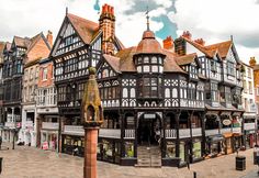 an old building in the middle of a town with lots of tall buildings on both sides