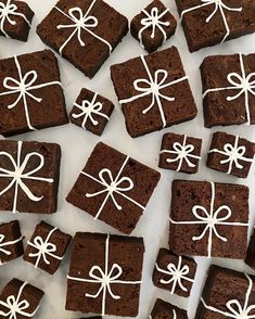 chocolate brownies with white icing and bows on them