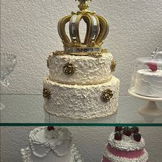 three tiered wedding cakes with gold crowns on top and white frosting, all decorated in different colors