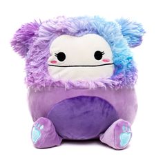 a purple and blue stuffed animal with big eyes