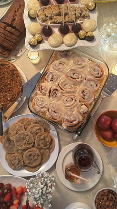 a table topped with lots of food and desserts