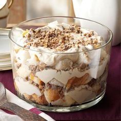 a glass bowl filled with dessert sitting on top of a table