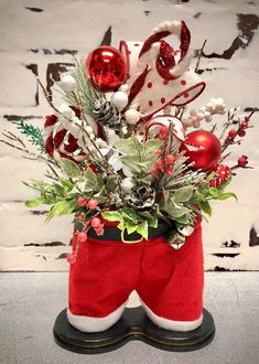 a christmas arrangement in a santa's stocking holder