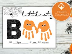 an orange and black halloween letter b with two little elephants on it