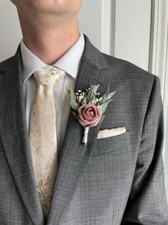 a man in a suit with a boutonniere on his lapel