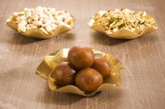 three bowls filled with food sitting on top of a table