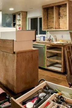 an open drawer in the middle of a kitchen with lots of clutter on it