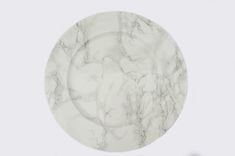 a white marble plate sitting on top of a table