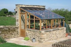 an old stone building with a glass roof