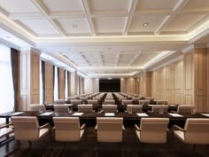 an empty conference room with long tables and chairs