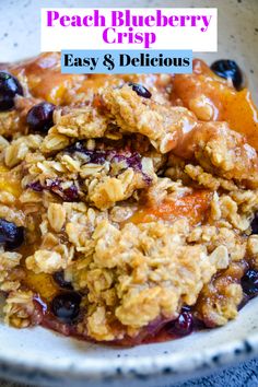 a bowl filled with granola and blueberry crisp on top of a white plate