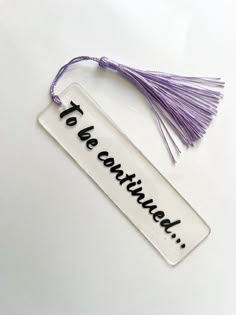 a tasseled tag with the words tea continental written on it and a purple tassel